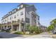 View of the exterior showcasing gray siding, stone accents, and a private balcony on a sunny day at 392 Concord St, Alpharetta, GA 30009