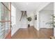 Light-filled foyer with hardwood floors, staircase, and neutral decor showcasing modern elegance at 392 Concord St, Alpharetta, GA 30009