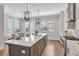 Modern kitchen with a large island, quartz countertops, stainless steel appliances, and ample natural light at 392 Concord St, Alpharetta, GA 30009