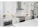 Chef's kitchen featuring premium stainless steel appliances, sleek countertops, and subway tile backsplash at 392 Concord St, Alpharetta, GA 30009