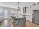 Bright kitchen featuring a large island, stainless steel appliances, and stylish pendant lighting at 392 Concord St, Alpharetta, GA 30009