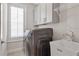 This laundry room features a modern washer and dryer, storage cabinets, and a utility sink at 392 Concord St, Alpharetta, GA 30009