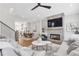 Open-concept living room with fireplace, connected to a dining area and kitchen at 392 Concord St, Alpharetta, GA 30009