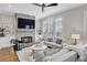 Inviting living room featuring a stone fireplace, hardwood floors, and ample natural light at 392 Concord St, Alpharetta, GA 30009