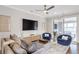 This living room features a large-screen tv, hardwood floors, modern furniture, and glass doors to the porch at 392 Concord St, Alpharetta, GA 30009