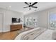 Bright main bedroom with a ceiling fan, plantation shutters, and modern furniture at 392 Concord St, Alpharetta, GA 30009