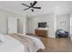 Relaxing main bedroom with a TV, and an area for a sitting chair at 392 Concord St, Alpharetta, GA 30009