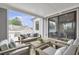 Inviting covered patio featuring comfortable seating and sliding glass doors to the interior at 392 Concord St, Alpharetta, GA 30009