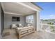 Charming covered patio with comfortable seating, a flat-screen TV, and neighborhood views at 392 Concord St, Alpharetta, GA 30009