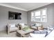 Relaxing covered patio features stylish seating, a flat-screen TV, and ample space at 392 Concord St, Alpharetta, GA 30009