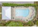 Overhead shot of a community pool with lounge chairs and shaded seating, surrounded by manicured landscaping at 392 Concord St, Alpharetta, GA 30009
