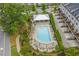 Aerial of a community pool with lounge chairs and an outdoor shelter, beautifully landscaped near townhomes at 392 Concord St, Alpharetta, GA 30009