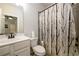 Bathroom with a shower and tub combo featuring a vanity with ample counter space and storage at 4832 Stone Way Path, Buford, GA 30519