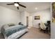 Bedroom featuring a ceiling fan, comfortable bed, work space and a doorway to an adjacent room at 4832 Stone Way Path, Buford, GA 30519