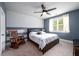Comfortable bedroom featuring a ceiling fan, carpet, and natural light from a window at 4832 Stone Way Path, Buford, GA 30519