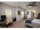 Spacious bedroom with a ceiling fan, neutral colored carpet and abundant natural light at 4832 Stone Way Path, Buford, GA 30519