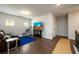 Bonus room with hard wood floors, a blue accent rug, leather seating and a TV at 4832 Stone Way Path, Buford, GA 30519