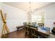 Bright dining room with hardwood floors, stylish chandelier, and wainscoting detail at 4832 Stone Way Path, Buford, GA 30519