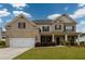 Charming two-story brick home with a manicured lawn, covered porch, and two car garage at 4832 Stone Way Path, Buford, GA 30519