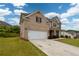 Side view of a brick two-story home with a well-manicured lawn and a driveway at 4832 Stone Way Path, Buford, GA 30519