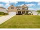 Beautiful brick two-story home with a well-manicured lawn and inviting front porch at 4832 Stone Way Path, Buford, GA 30519