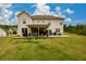 Rear exterior view showcasing a large backyard and covered patio ideal for entertainment at 4832 Stone Way Path, Buford, GA 30519