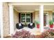 Inviting front porch with seating, decorative plants, and a welcoming entrance at 4832 Stone Way Path, Buford, GA 30519