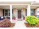Charming front porch with decorative plants, outdoor seating, and a welcoming front door at 4832 Stone Way Path, Buford, GA 30519