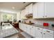 Charming kitchen featuring white cabinetry, granite countertops, and stainless appliances at 4832 Stone Way Path, Buford, GA 30519