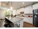 Spacious kitchen with a large island, granite countertops, and stainless steel refrigerator at 4832 Stone Way Path, Buford, GA 30519