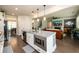 Open kitchen with a large center island, stainless appliances, and dark hardwood floors at 4832 Stone Way Path, Buford, GA 30519
