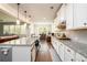 Bright kitchen with white cabinets, granite countertops, and stainless steel appliances at 4832 Stone Way Path, Buford, GA 30519