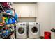 Functional laundry room with modern washer and dryer, shelving, and storage cabinets at 4832 Stone Way Path, Buford, GA 30519