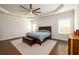 Serene main bedroom featuring a tray ceiling, hardwood floors, and a large window at 4832 Stone Way Path, Buford, GA 30519