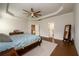 Bright main bedroom with hardwood flooring, tray ceiling, and ensuite bathroom access at 4832 Stone Way Path, Buford, GA 30519