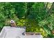 Aerial view of the backyard featuring a cozy fire pit area and a well-maintained brick home with a deck at 763 Old Paper Mill Se Dr, Marietta, GA 30067