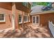 Relaxing brick home backyard with a spacious wooden deck and exterior lighting at 763 Old Paper Mill Se Dr, Marietta, GA 30067