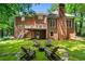 Private backyard with a fire pit and rustic wooden chairs, perfect for outdoor gatherings and relaxation at 763 Old Paper Mill Se Dr, Marietta, GA 30067