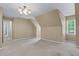 Spacious bedroom showcasing sloped ceilings, carpet floors, and a bright window at 763 Old Paper Mill Se Dr, Marietta, GA 30067