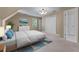 Neutral bedroom featuring a comfortable bed, a window view, and double door closets at 763 Old Paper Mill Se Dr, Marietta, GA 30067
