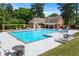 Community pool surrounded by lounge chairs and tables, ideal for relaxation and outdoor enjoyment at 763 Old Paper Mill Se Dr, Marietta, GA 30067