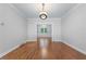 Bright dining room with hardwood floors, decorative molding and modern light fixture at 763 Old Paper Mill Se Dr, Marietta, GA 30067