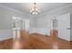 Spacious dining room featuring wainscoting, hardwood floors and decorative lighting at 763 Old Paper Mill Se Dr, Marietta, GA 30067