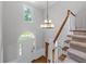 Elegant foyer with a chandelier, hardwood floors, staircase, and arched doorway for a grand entrance at 763 Old Paper Mill Se Dr, Marietta, GA 30067