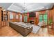 Cozy living room showcasing wood paneling, fireplace, built-in shelves, and a large chandelier at 763 Old Paper Mill Se Dr, Marietta, GA 30067