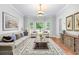 Comfortable living room features a large sofa, stylish rug, and bay windows overlooking the front yard at 763 Old Paper Mill Se Dr, Marietta, GA 30067