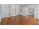 Spacious office area with hardwood floors and built-in bookshelves, perfect for working from home at 763 Old Paper Mill Se Dr, Marietta, GA 30067