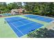 Community tennis courts with well-maintained blue courts and green surroundings for sports enthusiasts at 763 Old Paper Mill Se Dr, Marietta, GA 30067