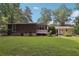 Lush backyard with well-maintained lawn and partial view of house and screened porch at 112 Pioneer Trail, Cartersville, GA 30121