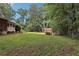 Large grassy backyard featuring shed and view of screened-in porch at 112 Pioneer Trail, Cartersville, GA 30121